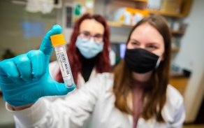 students and faculty working in lab.